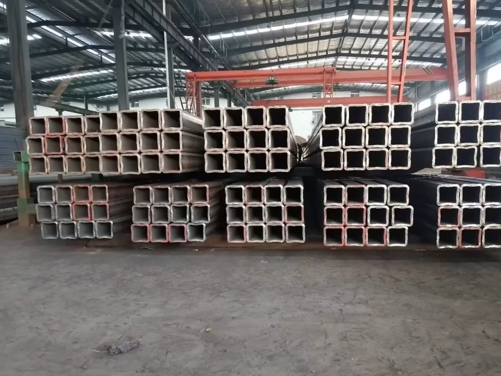 seamless carbon steel pipe supplier YIER storage yard with stacked black seamless pipes